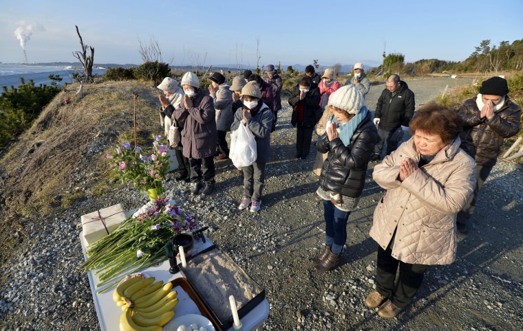 Image: People pray toward the sea to mourn victims of the March 11, 2011 earthquake and tsunami disaster in Fukushima prefecture