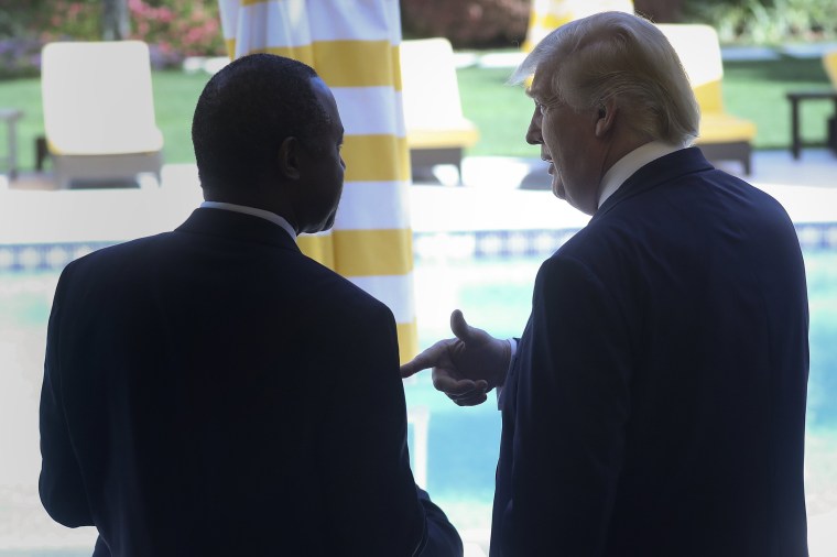 Image: Republican U.S. presidential candidate Donald Trump speaks with former Republican presidential candidate Ben Carson after receiving Carson's endorsement at a campaign event in Palm Beach