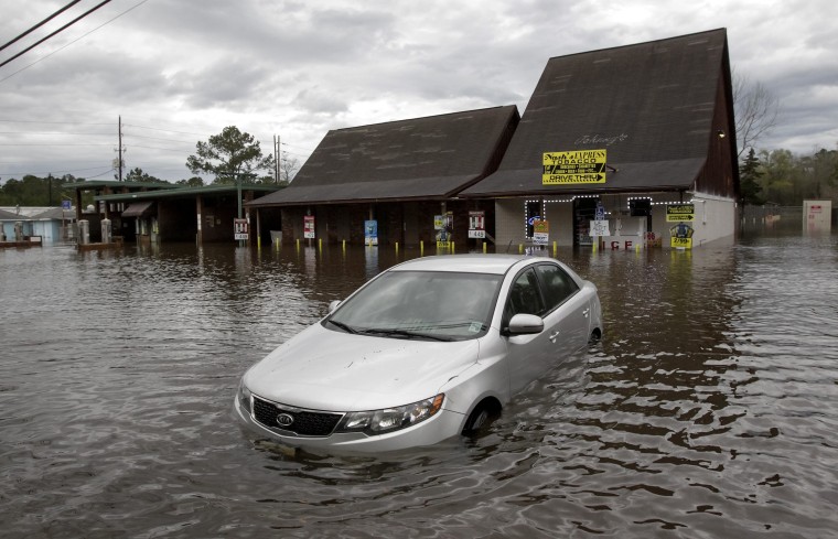 Image: A car sits in flooded water in Hammond, La., Friday, March.