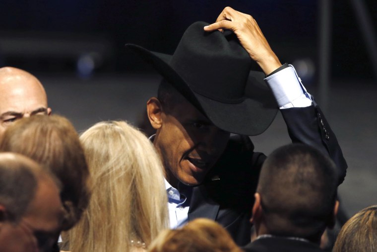 Image: Obama tries on a supporter's cowboy hat after delivering remarks at a DNC event at Gilley's Club in Dallas, Texas