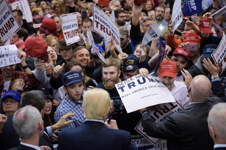 Image: Donald Trump signs autographs during a rally in Cleveland