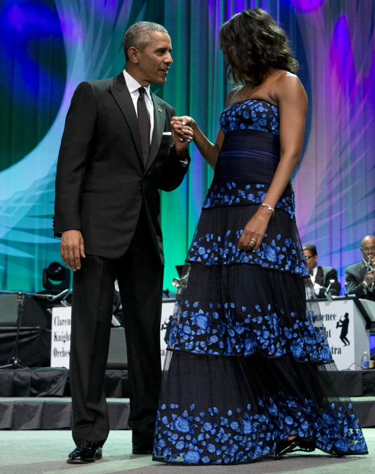 A photo of President Obama holding the hand of Michelle Obama