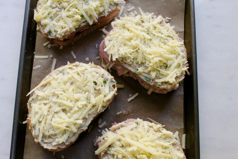 Croque Monsieur: Place the remaining bread on top with the béchamel side out and sprinkle with the remaining cheese
