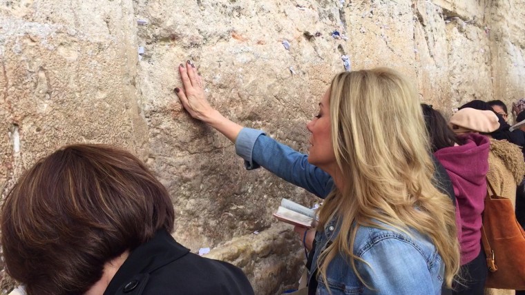 Kathie Lee Gifford prays at the Western Wall in Jerusalem after slipping a prayer for Hoda Kotb in between the stones at the wall.