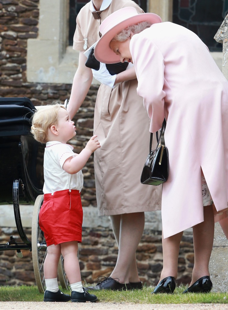 Prince George of Cambridge talks to Queen Elizabeth II outside the Church of St Mary Magdalene on the Sandringham Estate for the Christening of Princess Charlotte of Cambridge on July 5, 2015.