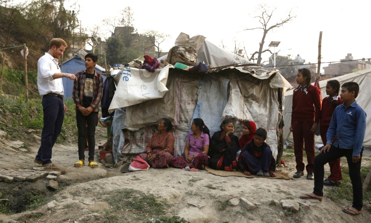 Prince Harry visits Nepalese families displaced by the 2015 earthquakes at a makeshift camp in Bhaktapur on March 20, 2016.