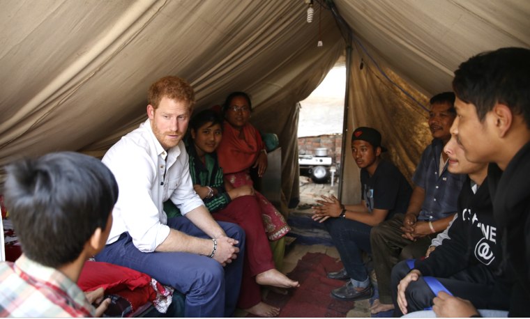 Prince Harry visits Nepalese families displaced by the 2015 earthquakes at a makeshift camp in Bhaktapur on March 20, 2016.