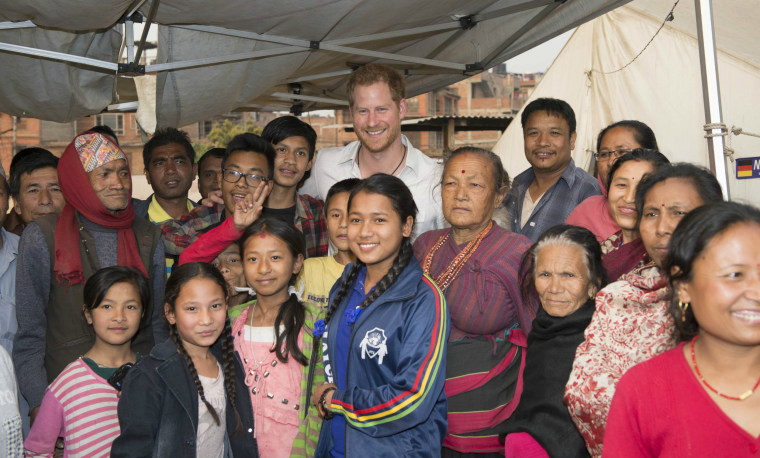 Prince Harry smiles for a photo with families displaced by the 2015 earthquake on March 20, 2016 near Kathmandu, Nepal.