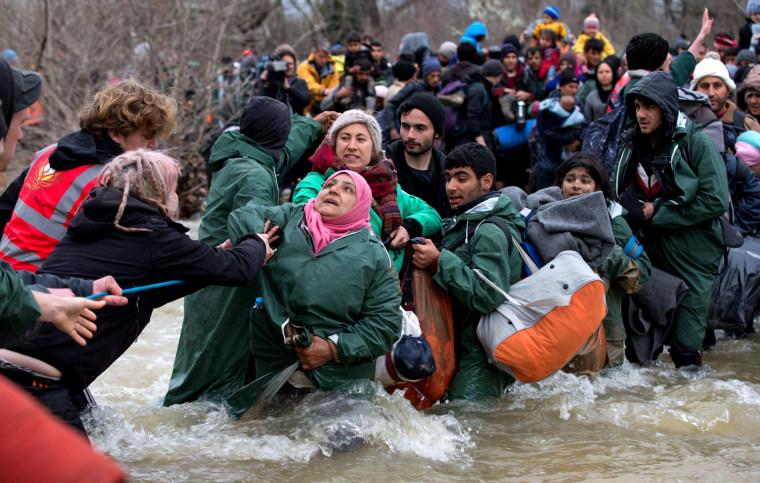 Image: Frustrated Migrants Stranded On The Border Attempt To Walk In To Macedonia