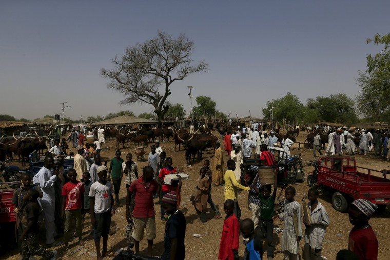 Image: People gather at the cattle market