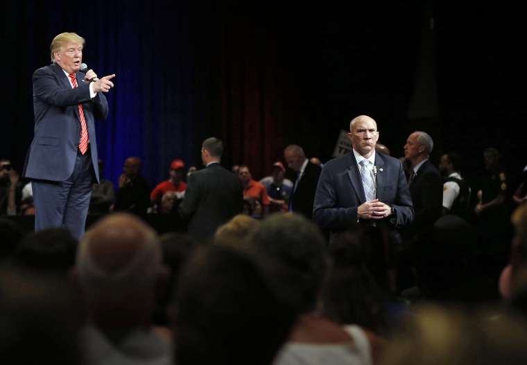 Image: Secret Service agents stand watch Donald Trump