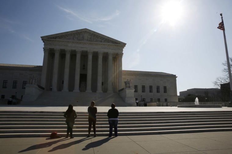 Image: Three anti-abortion protestors are seen outside U.S. Supreme Court building is seen in Washington