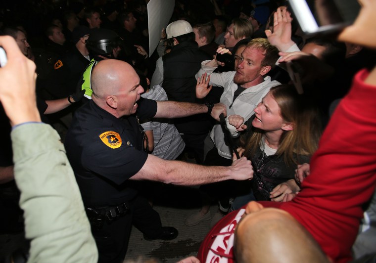 Salt Lake Police push protesters back at a rally outside where Donald Trump held a campaign rally Friday.