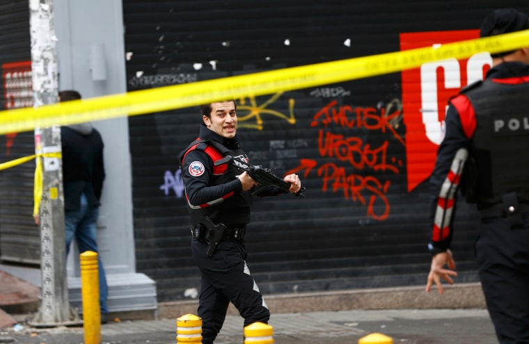 Image: Police secure the area following a suicide bombing in a major shopping and tourist district in central Istanbul
