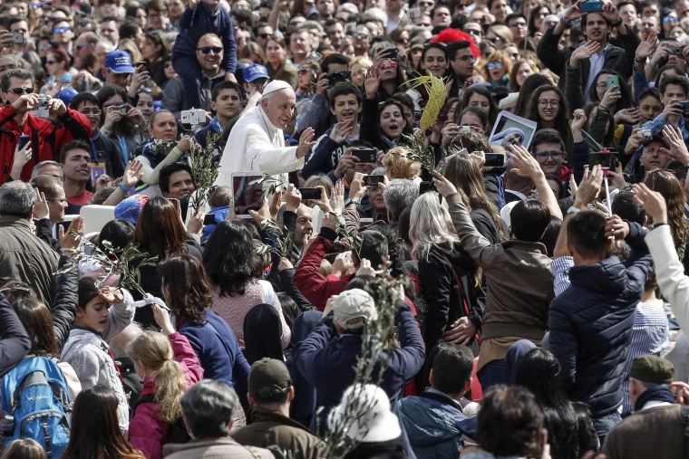 Image: Pope Francis waves during the Palm Sunday Mass
