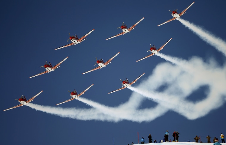 Image: Members of the Swiss Air Force PC 7 team fly in formation over the Alpine Skiing World Cup finals in St. Moritz