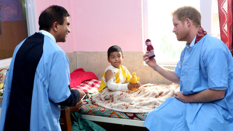 Image: Britain's Prince Harry visits a patient at the burn unit of Kanti Children's Hospital