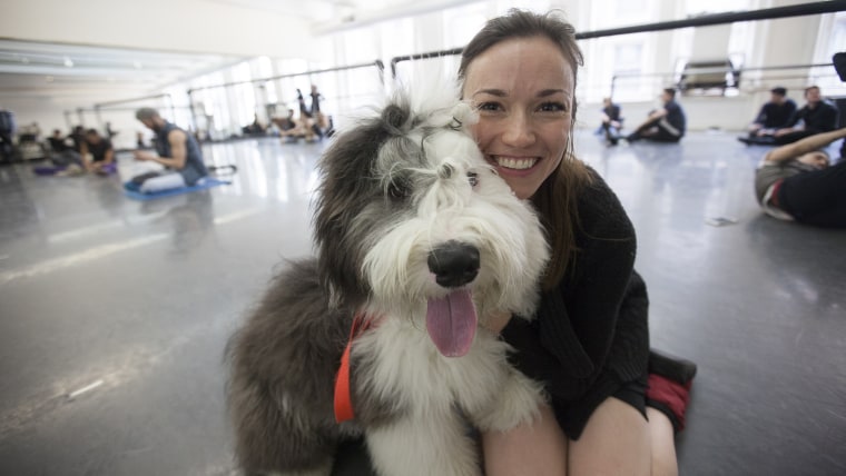 Sarah Smith poses with her dog, Hudson, an Old English sheep dog,