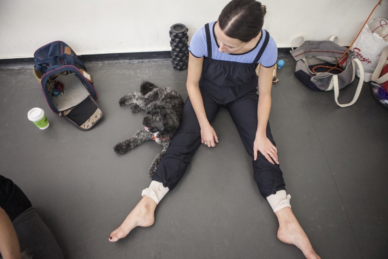 Devon Teuscher stretches with her dog, Riley, at the American Ballet Theatre