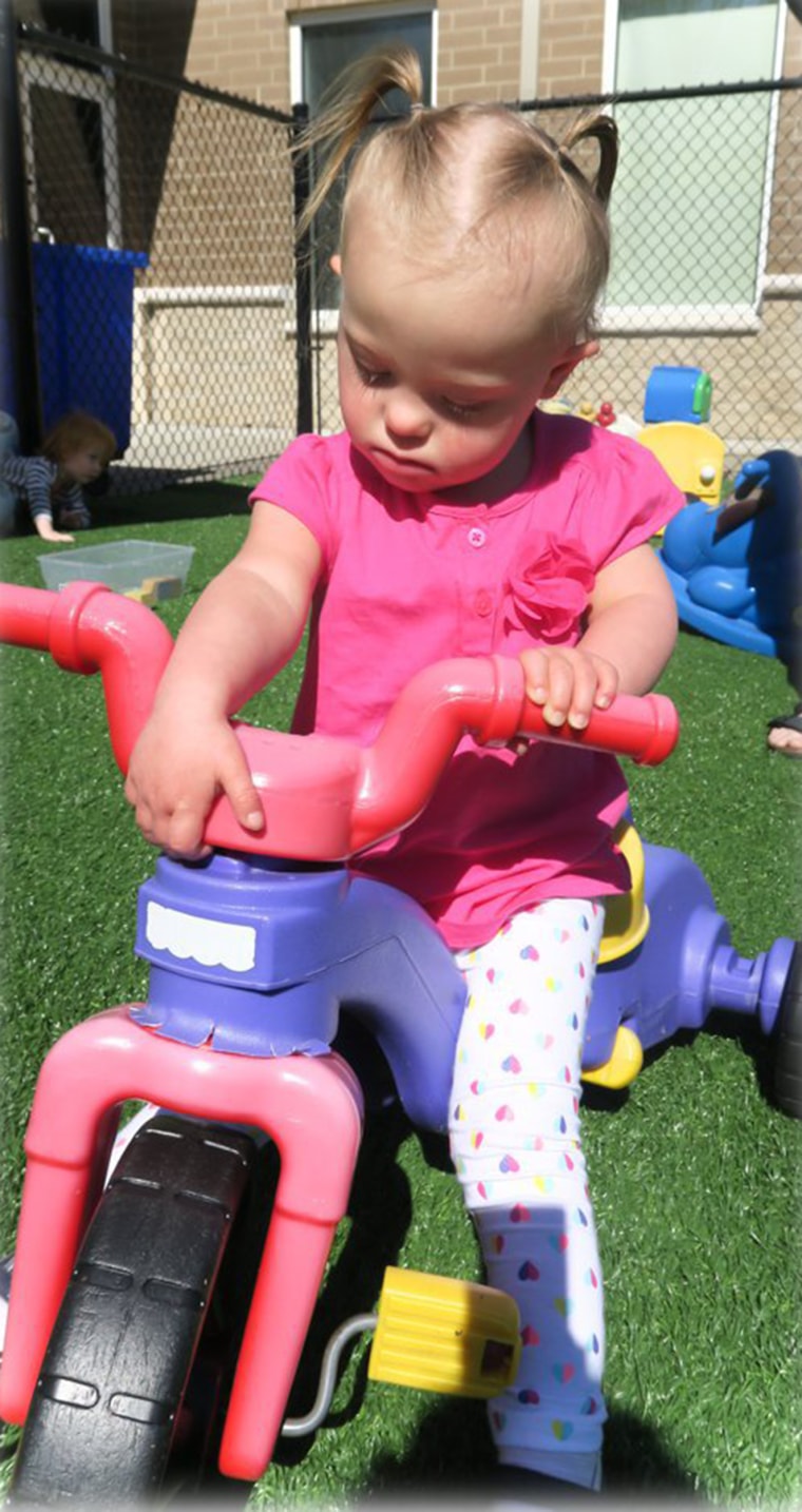 Image Joey and Rory Feek's daughter, Indiana, playing on a bicycle