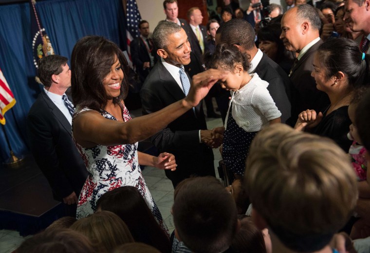 Image: President Barack Obama and First Lady Michelle Obama greet U.S. embassy staff