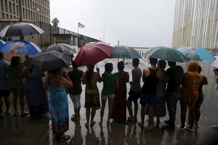 Image: People gather beside the U.S. embassy in Havana