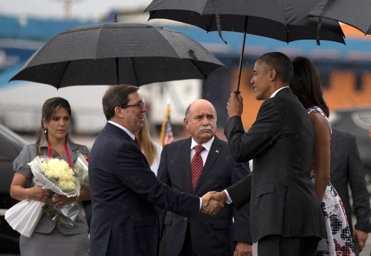 Image: President Barack Obama, right, shakes hands with Cuba's Foreign Minister Bruno Rodriguez as first lady Michelle Obama stands behind