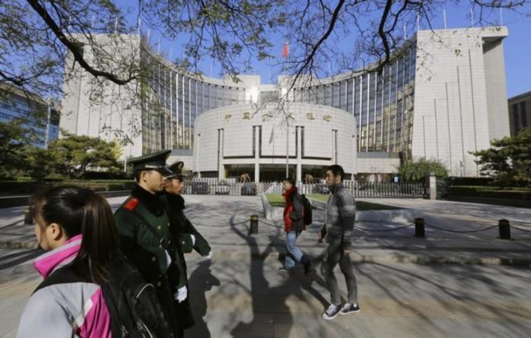 People walk past PBOC headquarters in Beijing