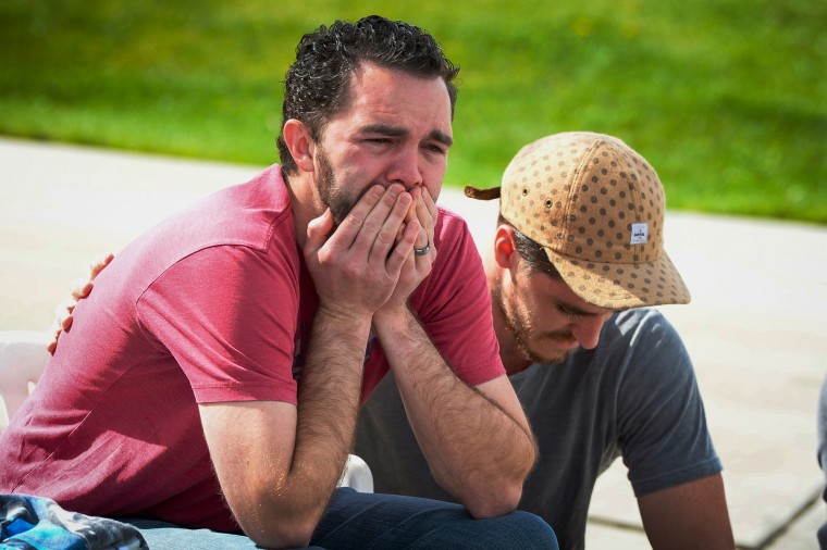 Image: Rusty Page, foster father to Lexi, 6, is comforted by Graham Kelly