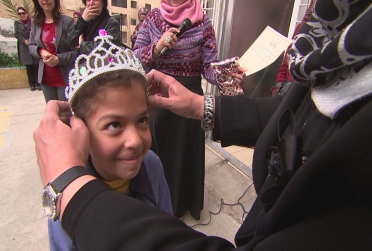 Image: Hanaa Al Fasih, age 7, being crowned by principal Maha Al Ashqar