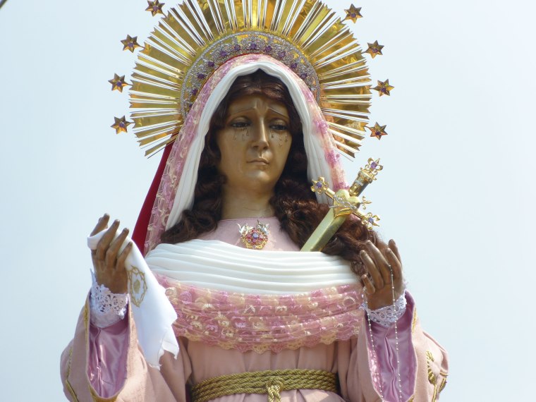 Women carry the andas platform with statue of the Virgin Mary, and the men carry the statue of a fallen Jesus Christ.