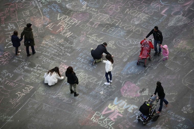 Image: People write messages on the ground at Place de la Bourse