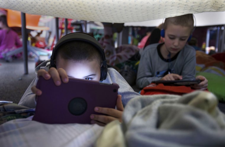 Mauricio Hernandez, left, and Parker Niccum work on coding in Angela Larsen's second grade classes at Howard Elementary School while participating in an “Hour of Code” - a global project that serves as a way for people, and especially students, to become familiar with code and technology in Eugene, Ore., on Dec. 9, 2015. The second grade students did their coding in “coding forts” built out of blankets, tables and chairs.