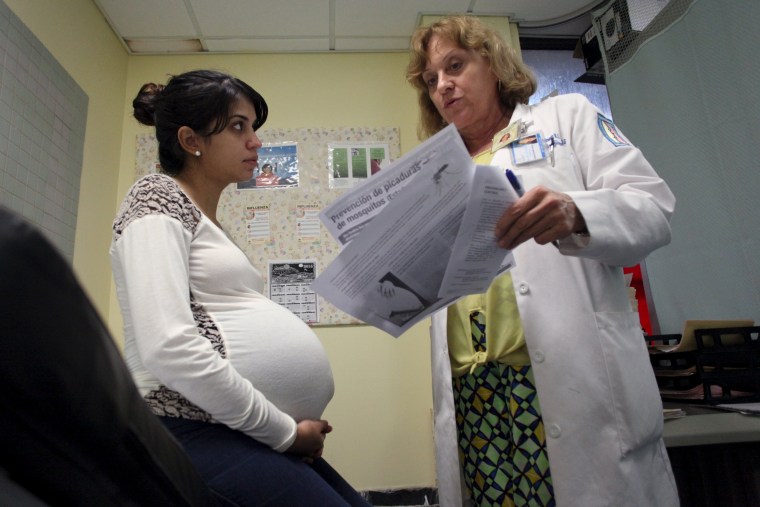 Image: Nancy Trinidad, who is 32 weeks pregnant, listens to the explanation of a doctor about how to prevent Zika, Dengue and Chikungunya viruses at a public hospital in San Juan