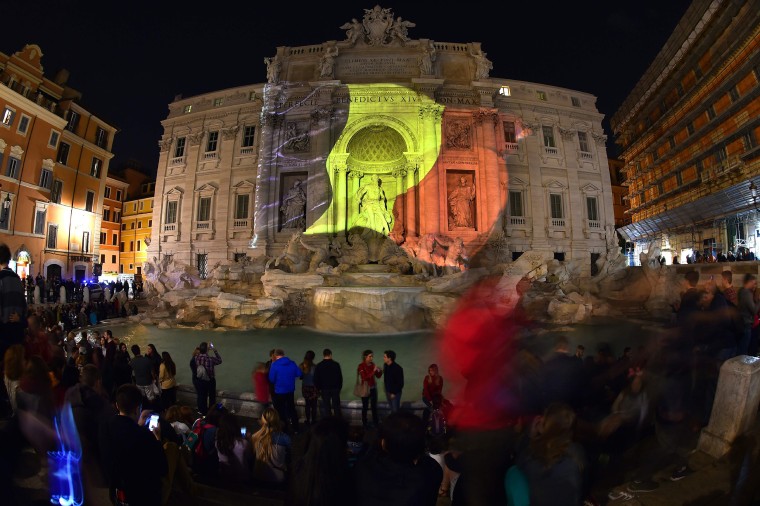 Image: A Belgian flag is display on the Trevi Fountain in Rome