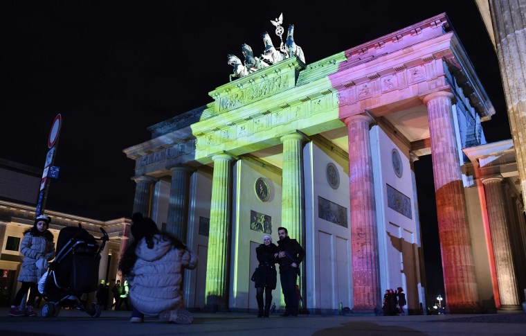 Image: The colors of the Belgian flag are projected on to the Brandenburg Gate