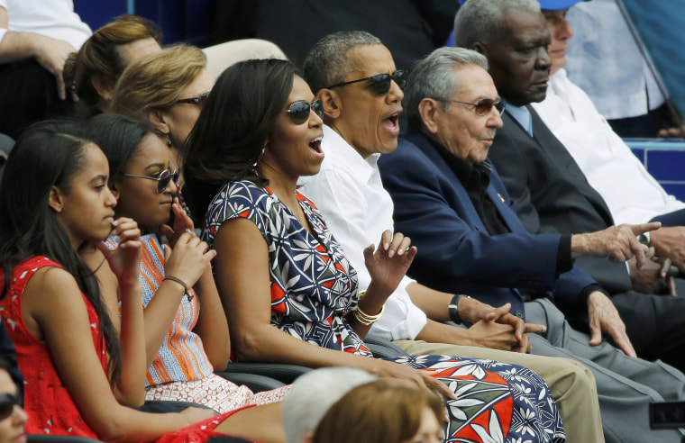 Image: U.S. President Barack Obama and his family react along with Cuban President Raul Castro to an exhibition baseball game in Havana