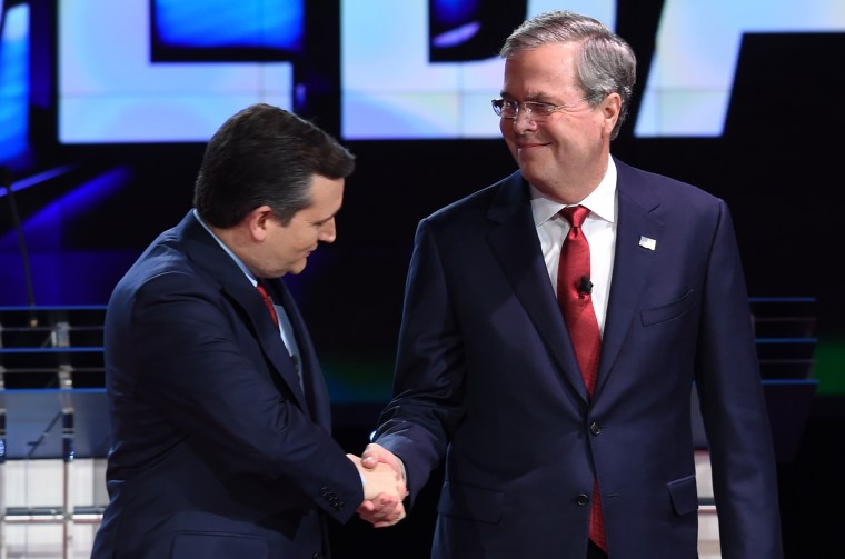 Image: Republican presidential candidate Texas Sen. Ted Cruz (L) shakes hands with  ormer Gov. Florida Jeb Bush