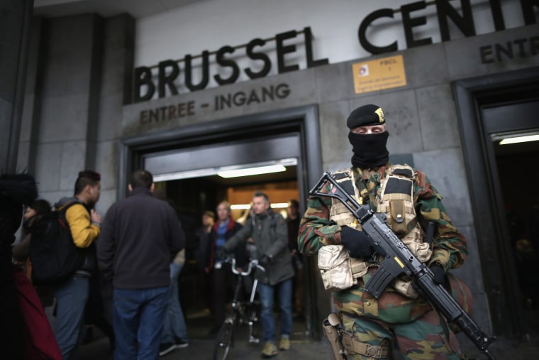 Image: Armed soldiers guard the entrance to Brussels Central Station