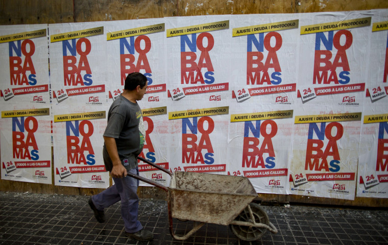 Image: Banners reading in Spanish "No more" protest against the visit of United States President Barack Obama.