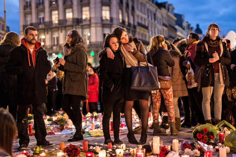 Image: People gather at a memorial site for the victims of attacks in Brussels