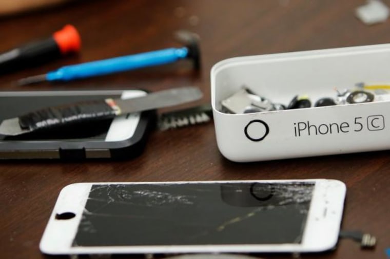 Pieces of an iPhone are seen on a repair store in New York