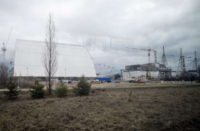 A general view shows a containment shelter for the damaged fourth reactor and the New Safe Confinement structure at the Chernobyl Nuclear Power Plant