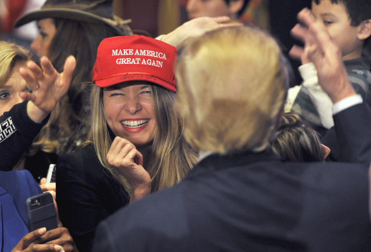 Image: A woman smiles after getting an autograph by U.S. Republican presidential candidate and businessman Donald Trump on her hat after he spoke at a campaign rally South Point Resort and Casino in Las Vegas