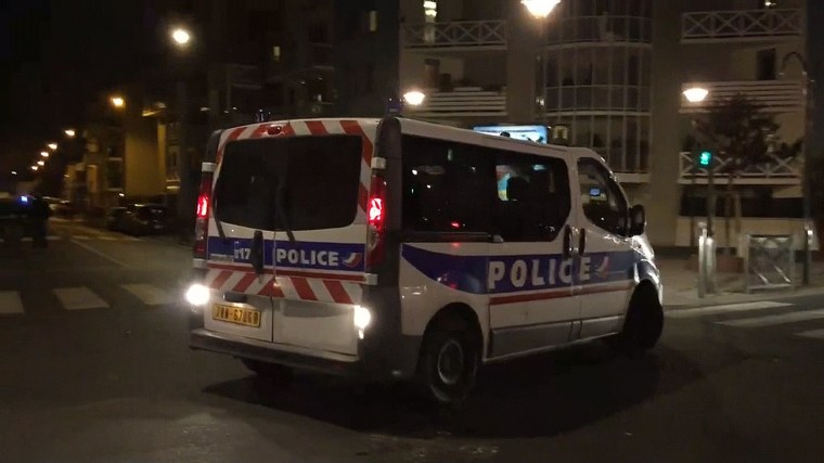 A French police vehicle during raids in a suburb north of Paris.