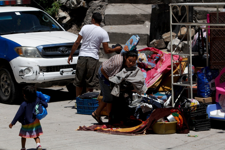 Residents gather their belongings while fleeing Las Torres neighbourhood.