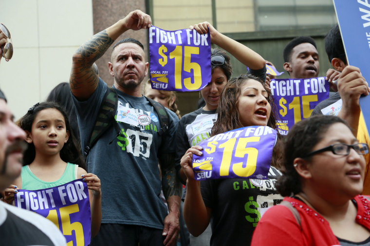 In this Tuesday, July 21, 2015 file photo, workers hold a rally in Los Angeles in support of the Los Angeles County Board of Supervisors' proposed minimum wage ordinance. On Saturday, March 26, California legislators and labor unions reached an agreement that will take the state's minimum wage from $10 to $15 an hour.