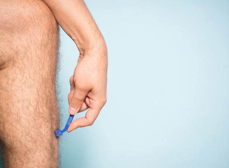 Man shaving his legs.