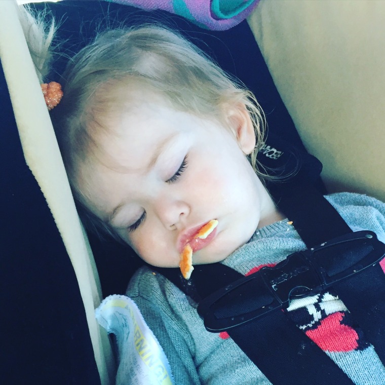 Toddler sleeping with cheese crackers hanging out of her mouth