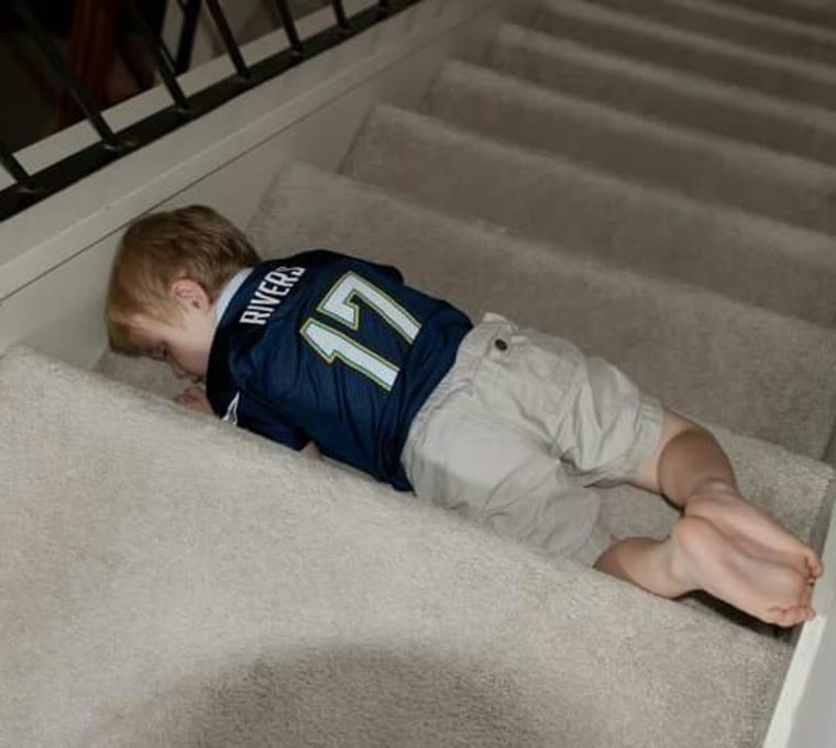 Boy sleeping on a stair
